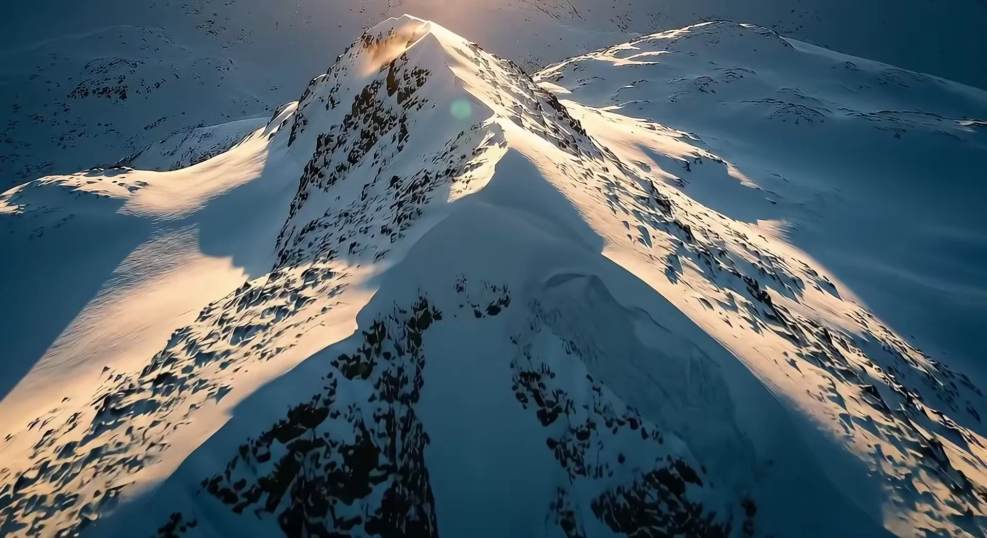 Snow-covered Nordic mountains at sunset, from Arcem’s introductory film.